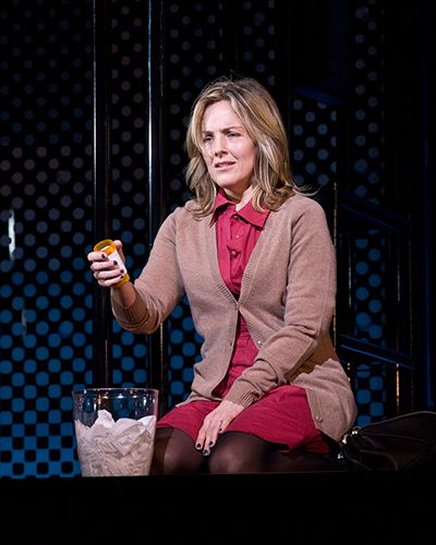 Diana (Alice Ripley) secretly dumps her pills into the toilet.