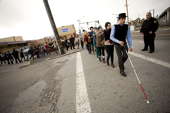 Photo of author leading a large group in 2012 on a Blind Field Shuttle walking tour on the San Francisco campus of the California College of the Arts.