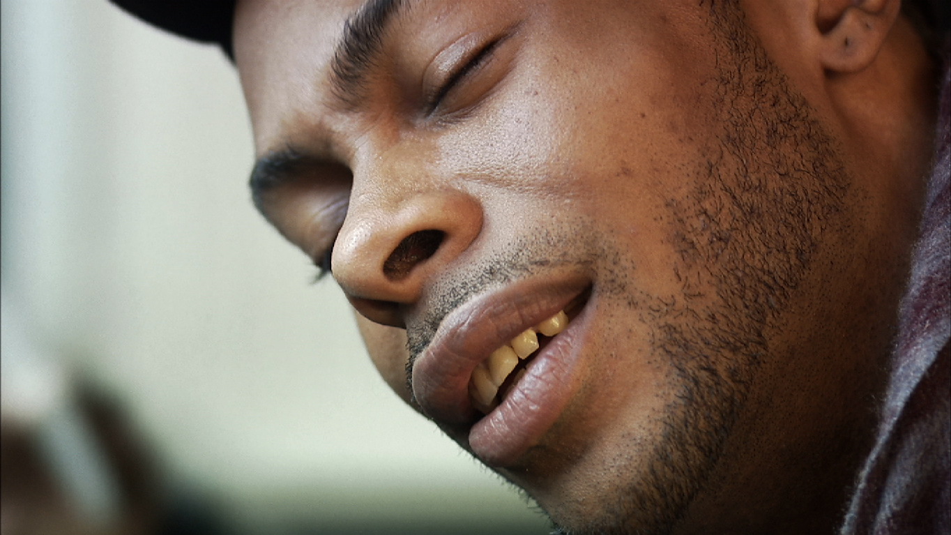 Drew bends his ear to listen closely for an inscrutable sound.