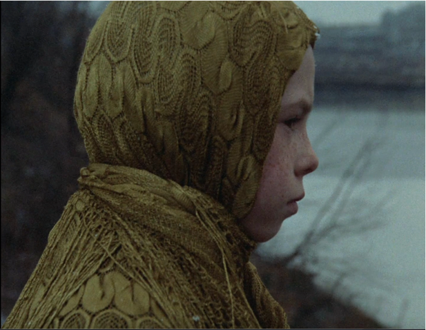 Photo of a young girl wearing a yellow headscarf