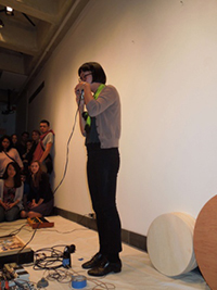 Christine makes loud noise with her voice as she holds the microphone closely to her mouth.