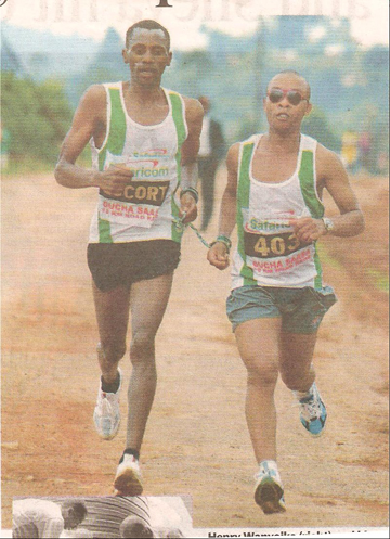scan of photograph showing two runners, one blind, holding the two ends of a rope while running