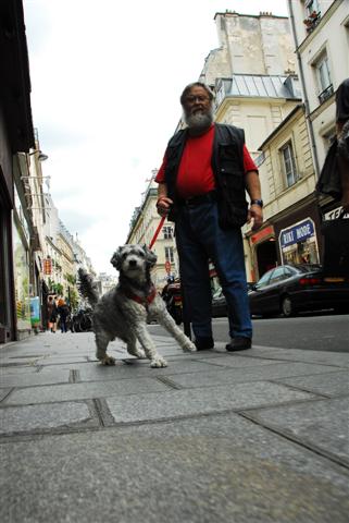 photograph titled Man and Dog; Paris, France (2007)