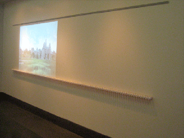 View of Landscape, from the installation artwork Admission, 2008, by J. Eisenhauer. The work juxtaposes a digital projection of a postcard of the since demolished Ohio Lunatic Asylum with a baseline of psychopharmacological pill bottles collected by the artist-author. Used with permission of Jennifer Eisenhauer and Disability Studies Quarterly